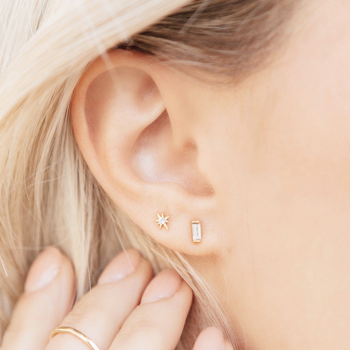 Picture of the Golden Earring Set by Katie Dean Jewelry, showing one tiny star stud and one baguette stud earring, handmade in the USA