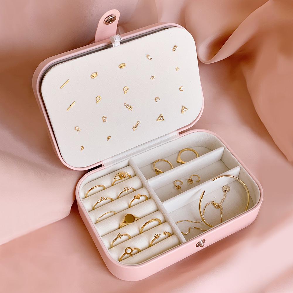 pink leather jewelry carrying case with dainty Katie Dean Jewelry gold jewelry pieces in it