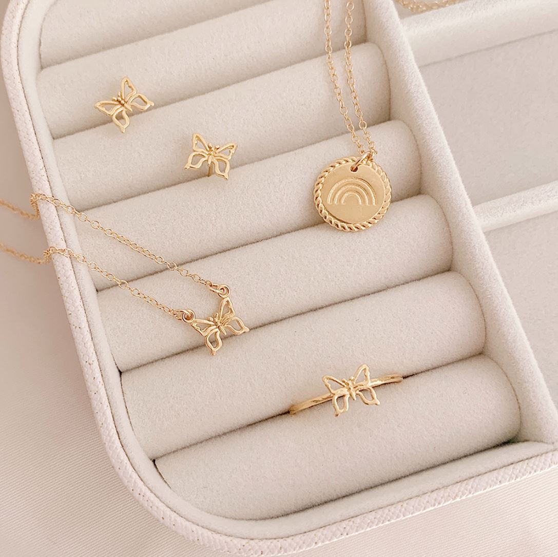 White jewelry box showing the dainty gold Rainbow Necklace, Butterfly Necklace, Butterfly Stud Earrings and Butterfly Ring handmade in America by Katie Dean Jewelry