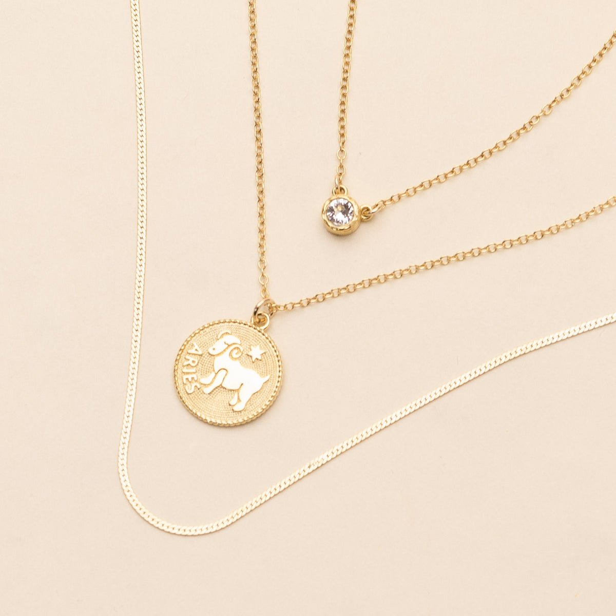 Image of three dainty, delicate and minimal layering necklaces handmade in America by Katie Dean, featuring the Birthstone Necklace, Aries Zodiac Horoscope Necklace and Herringbone Chain