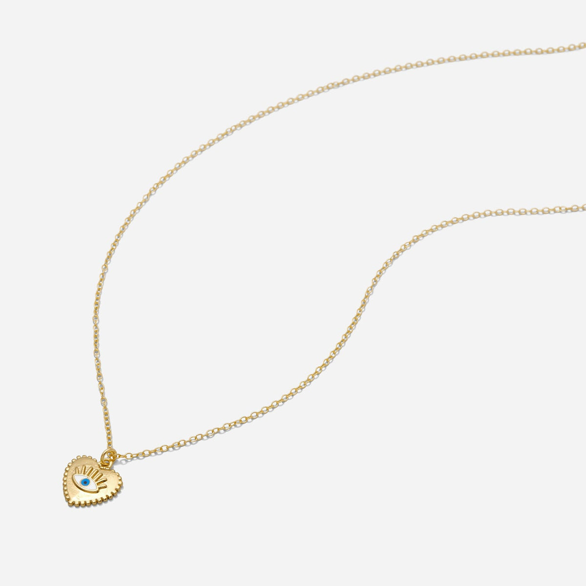 Gold necklace with a heart-shaped pendant on a white background, made by Katie Dean Jewelry.