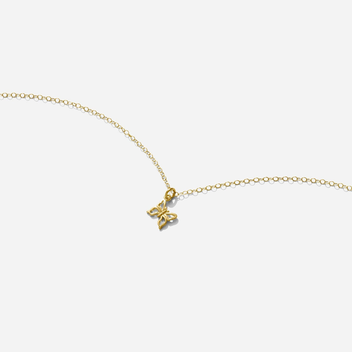 Gold Butterfly Necklace handmade in America by Katie Dean Jewelry, as seen on a natural white background, perfect for the dainty minimal jewelry lovers.