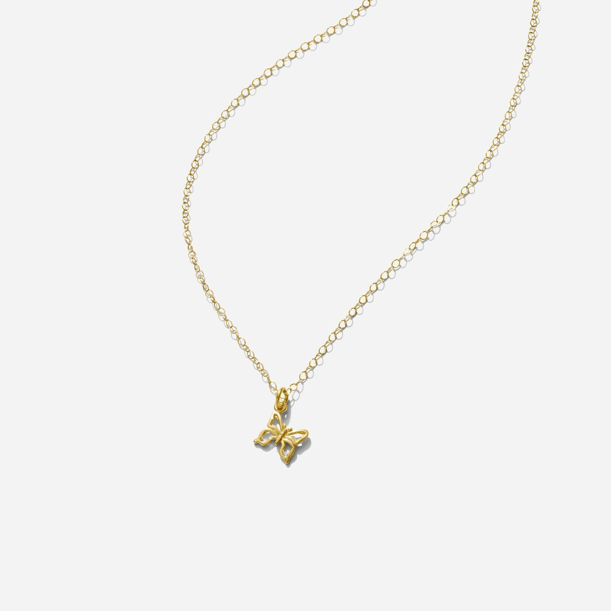 Gold Butterfly Necklace handmade in America by Katie Dean Jewelry, as seen on a natural white background, perfect for the dainty minimal jewelry lovers.