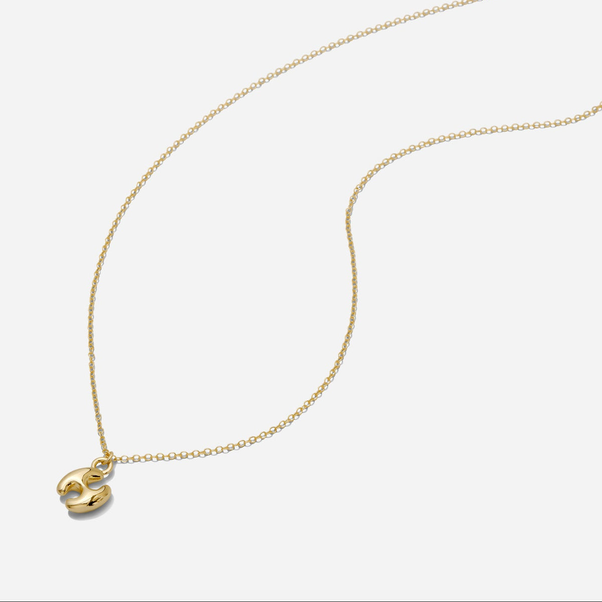 Dainty Gold puffy initial "H" pendant necklace on an 18-inch gold filled chain as seen on a white background.