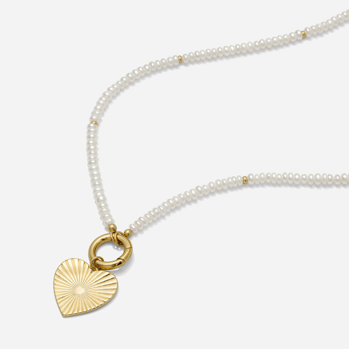 Pearl necklace with a gold heart-shaped pendant on a white background handmade by Katie Dean Jewelry in Clearwater, FL.