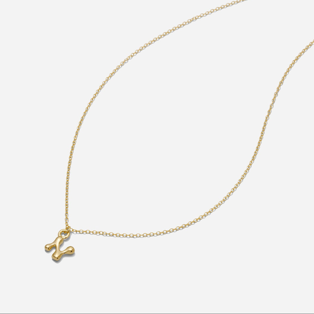 Dainty Gold puffy initial "N" pendant necklace on an 18-inch gold filled chain as seen on a white background.
