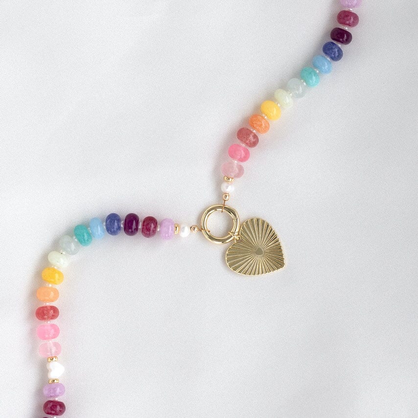 Necklace with colorful beads and a gold clasp with gold heart charm on a white background