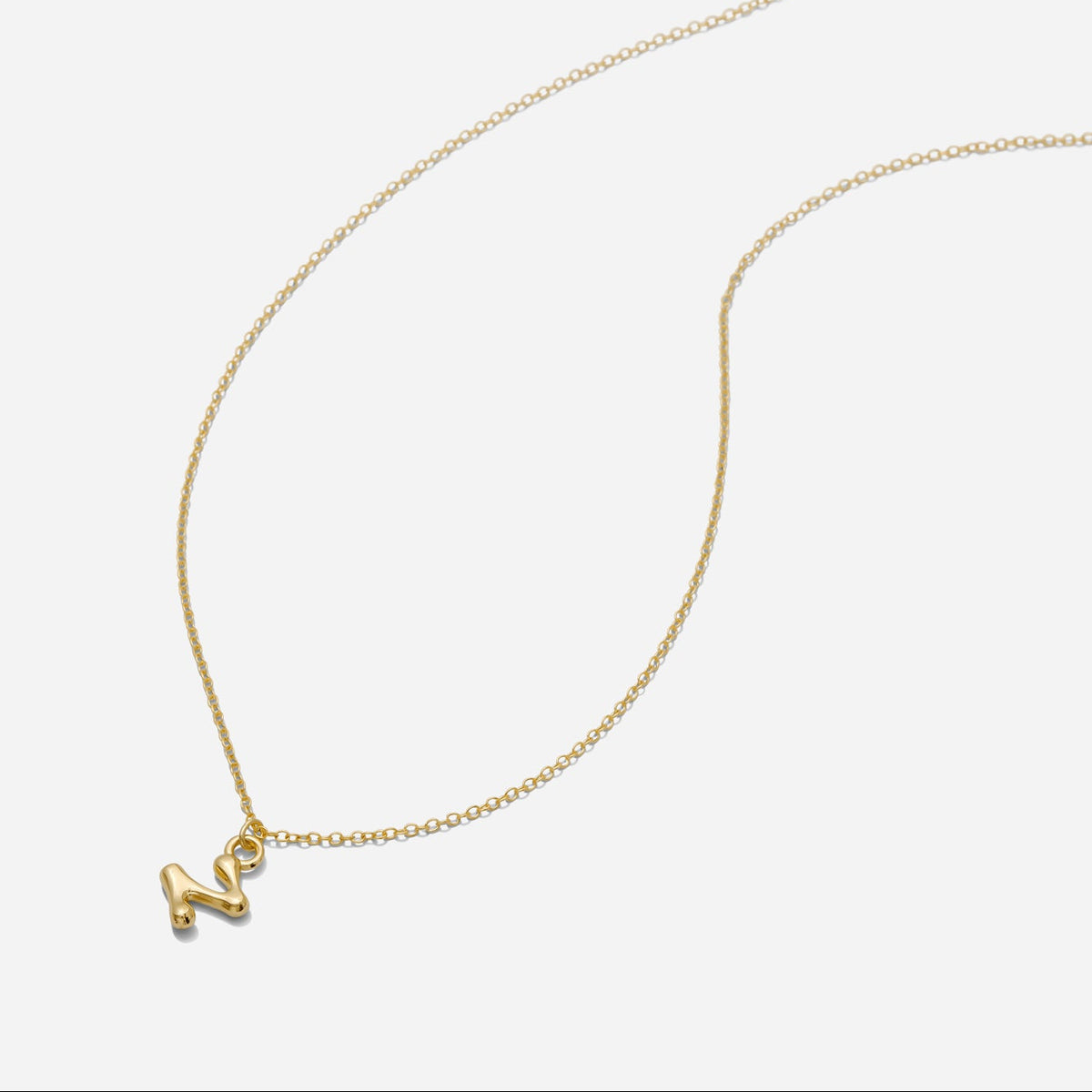 Dainty Gold puffy initial "Z" pendant necklace on an 18-inch gold filled chain as seen on a white background.