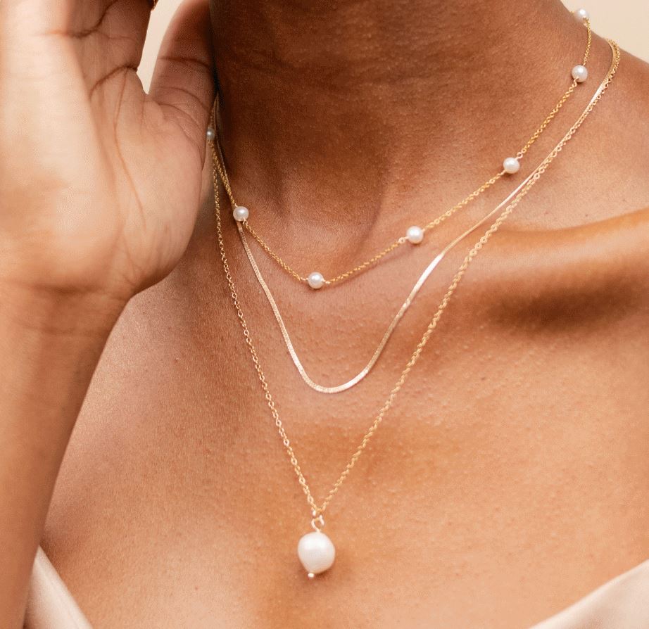 Bride jewelry, minimal delicate gold necklaces featuring a pearl necklace, herrinbonenecklace and long pearl solo pendant necklace, by Katie Dean Jewelry