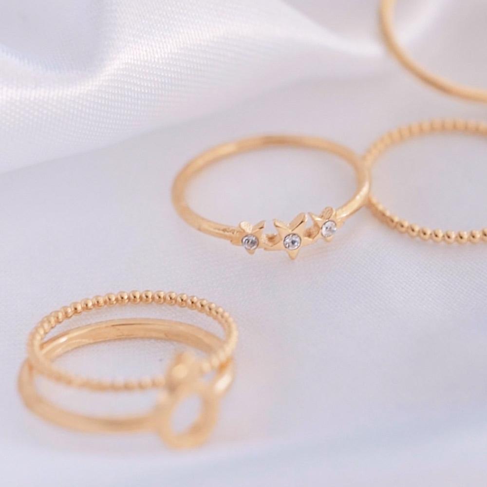 Katie Dean rings on white material background. 