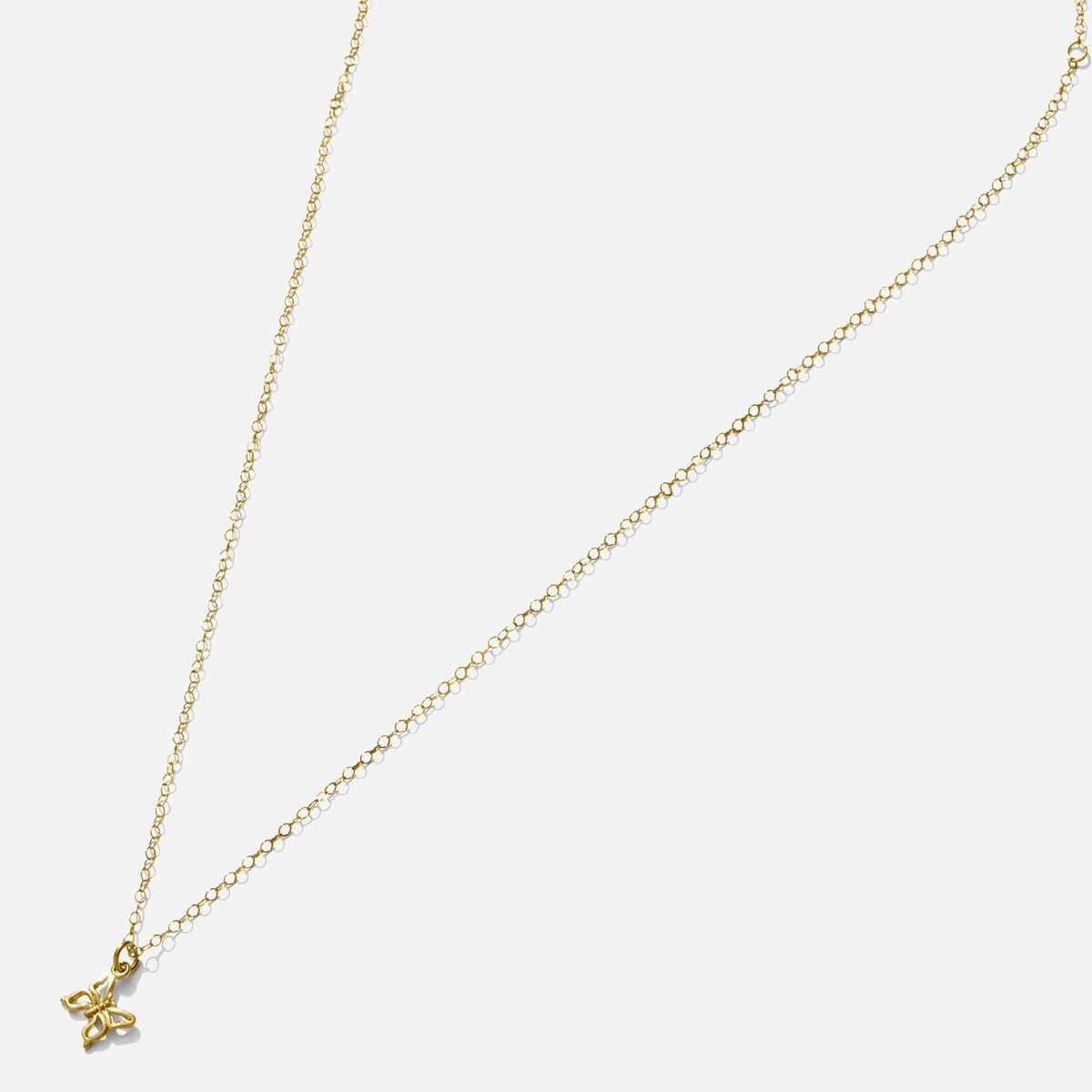 Gold Butterfly Necklace handmade in America by Katie Dean Jewelry, as seen on a natural white background, perfect for the dainty minimal jewelry lovers.
