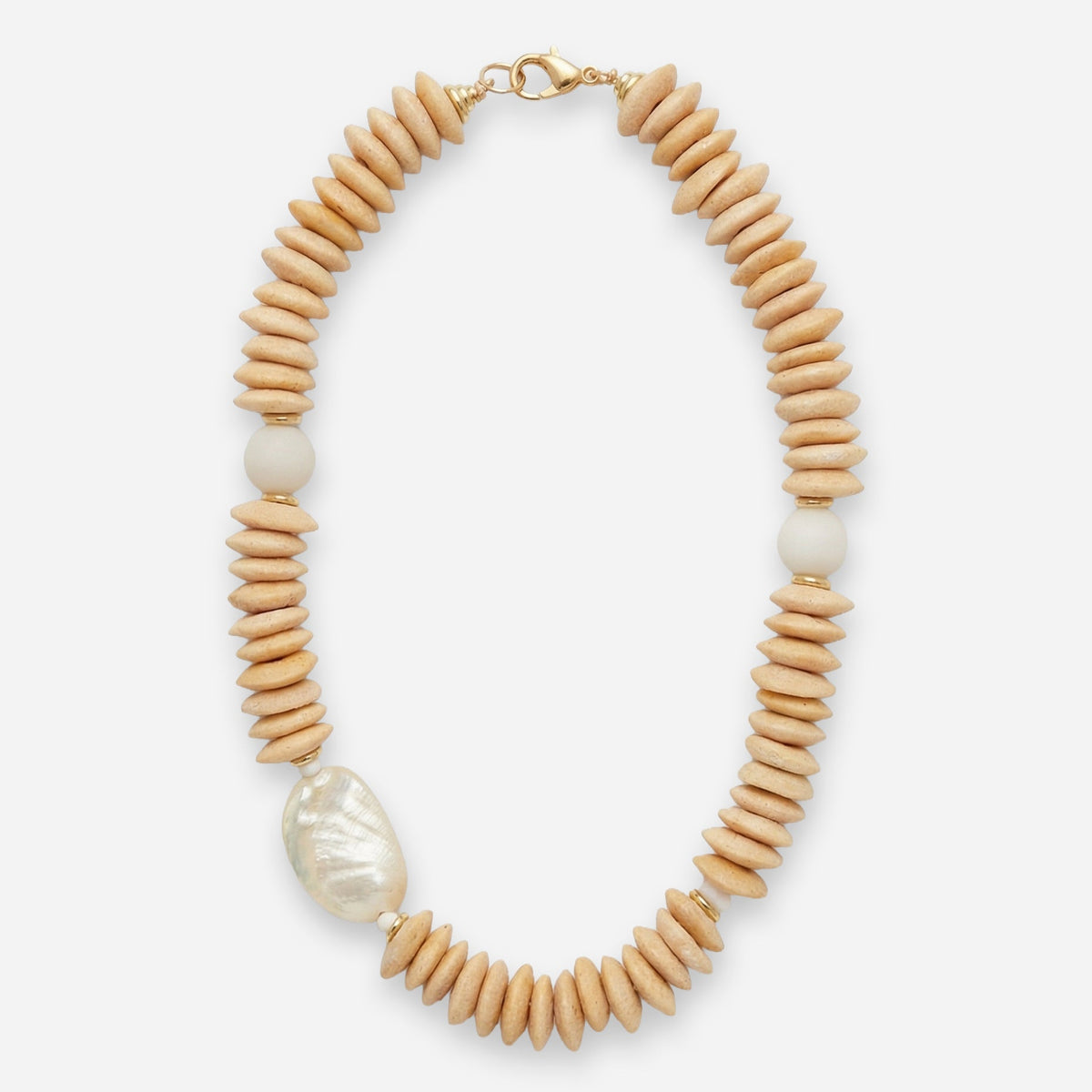Necklace with cream beads and a large shell pendant on a white background