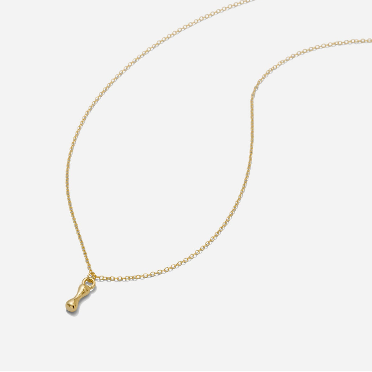 Dainty Gold puffy initial "I" pendant necklace on an 18-inch gold filled chain as seen on a white background.