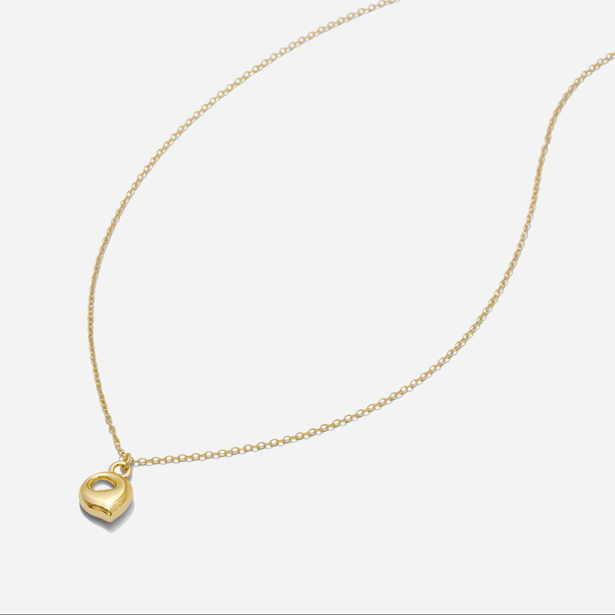 Dainty Gold puffy initial "Q" pendant necklace on an 18-inch gold filled chain as seen on a white background.