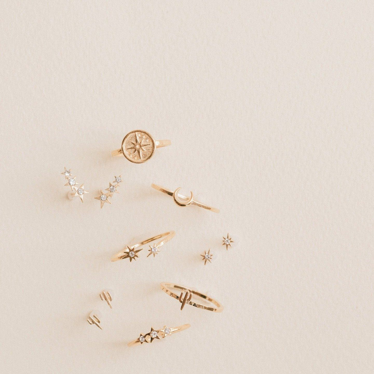 Eight pointed star ring show with other golden jewels made by Katie Dean Jewelry.